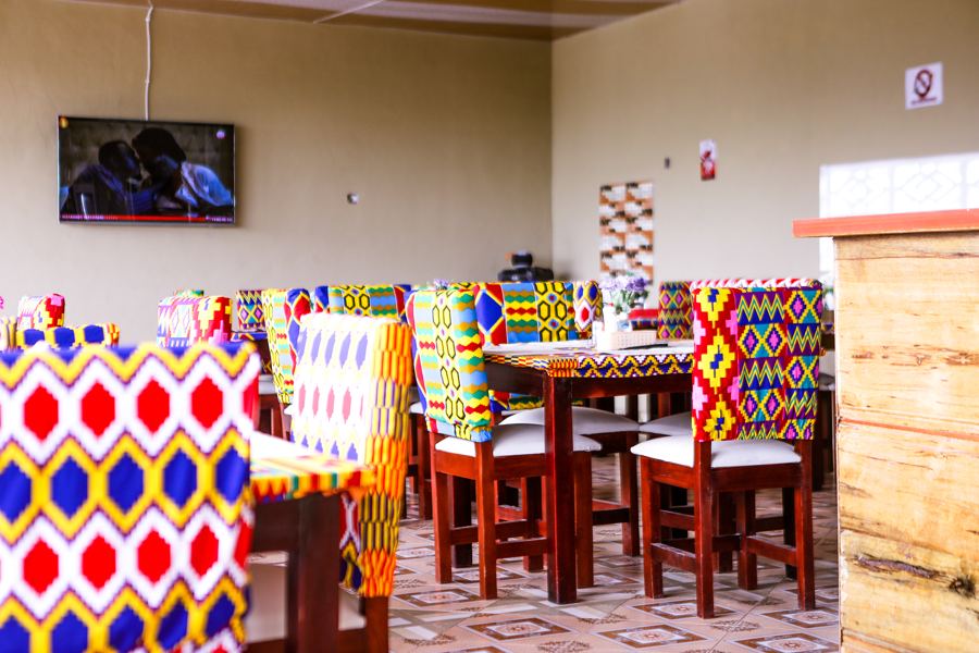 The restaurant, with kente-patterned chairs